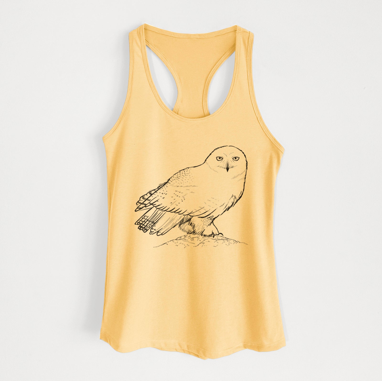 Banana cream women's racerback tank top laid flat, printed with a detailed black ink illustration of a snowy owl perched on a snowy mound.