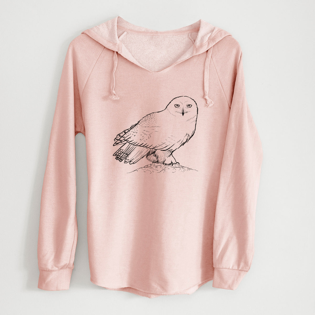 Blush pink women's Cali Wave hooded sweatshirt laid flat, printed with a detailed black ink illustration of a snowy owl perched on a snowy mound.