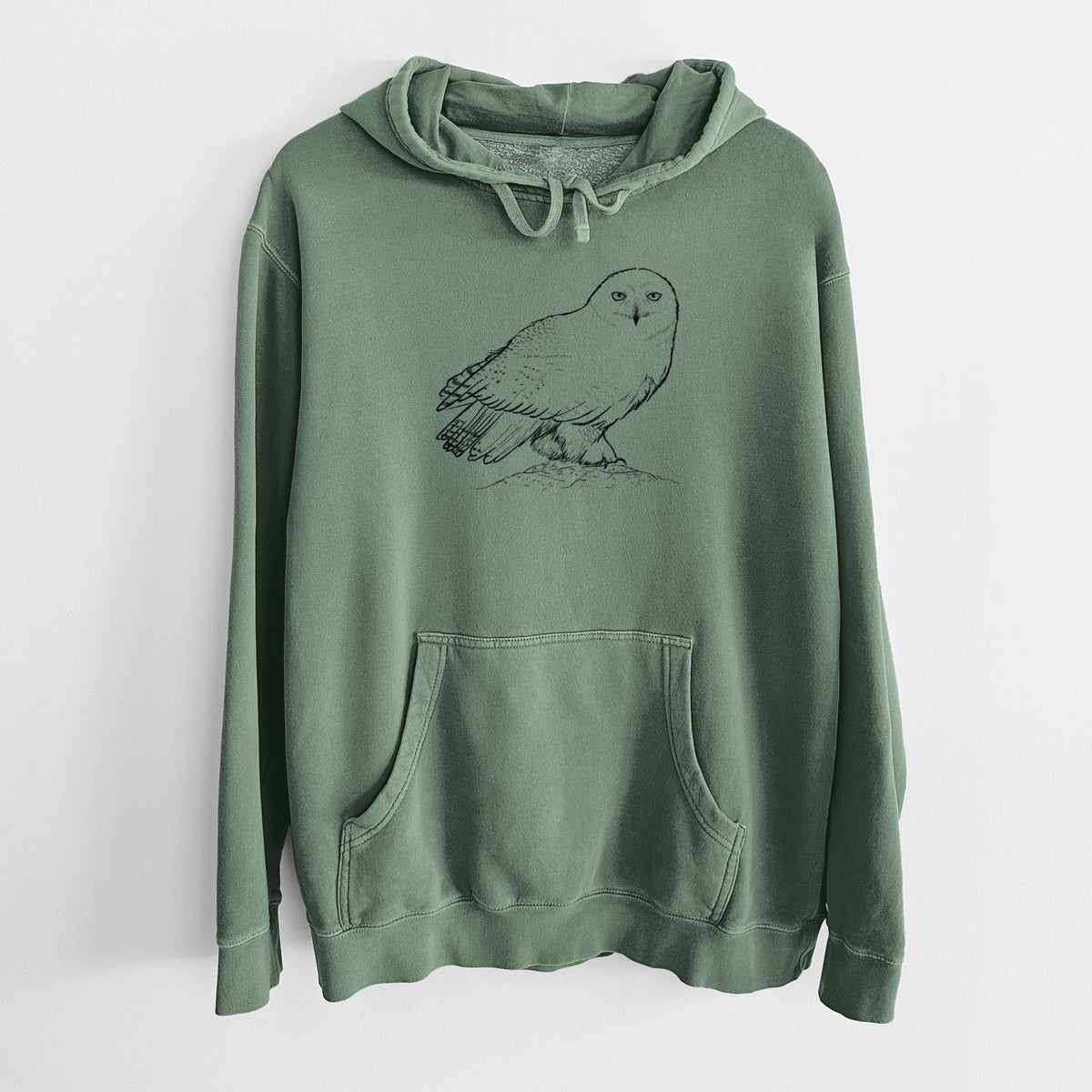 Alpine green pigment dyed hoodie laid flat, printed with a detailed black ink illustration of a snowy owl perched on a snowy mound.