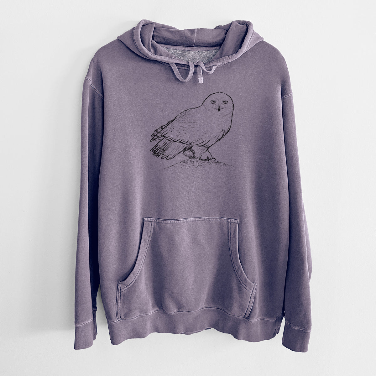 Plum purple pigment dyed hoodie laid flat, printed with a detailed black ink illustration of a snowy owl perched on a snowy mound.