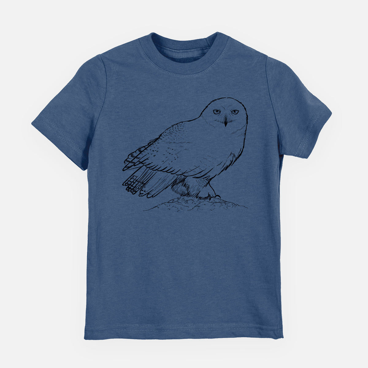 Indigo blue youth t-shirt laid flat, printed with a detailed black ink illustration of a snowy owl perched on a snowy mound.