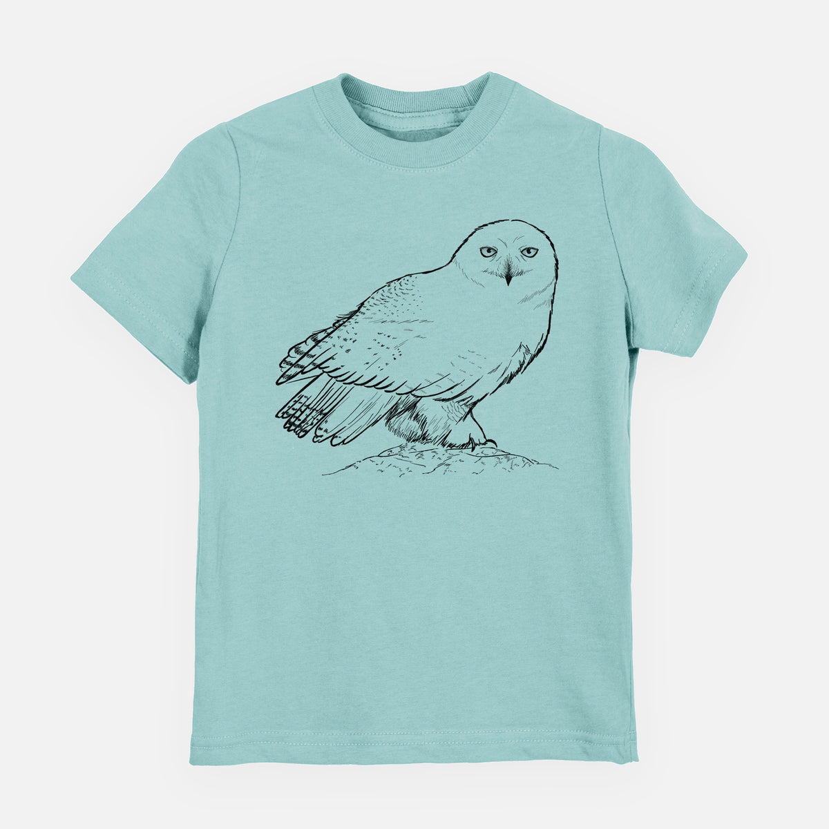 Saltwater youth t-shirt laid flat, printed with a detailed black ink illustration of a snowy owl perched on a snowy mound.