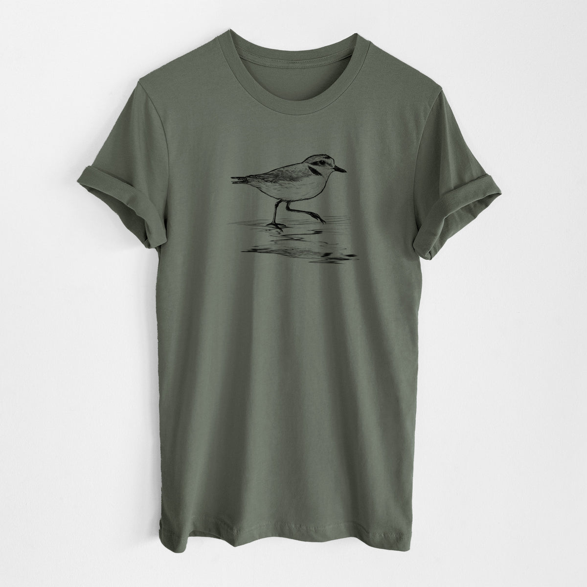 Military green lightweight cotton t-shirt laid flat, printed with a black ink sketch of a snowy plover running along the wet shoreline.