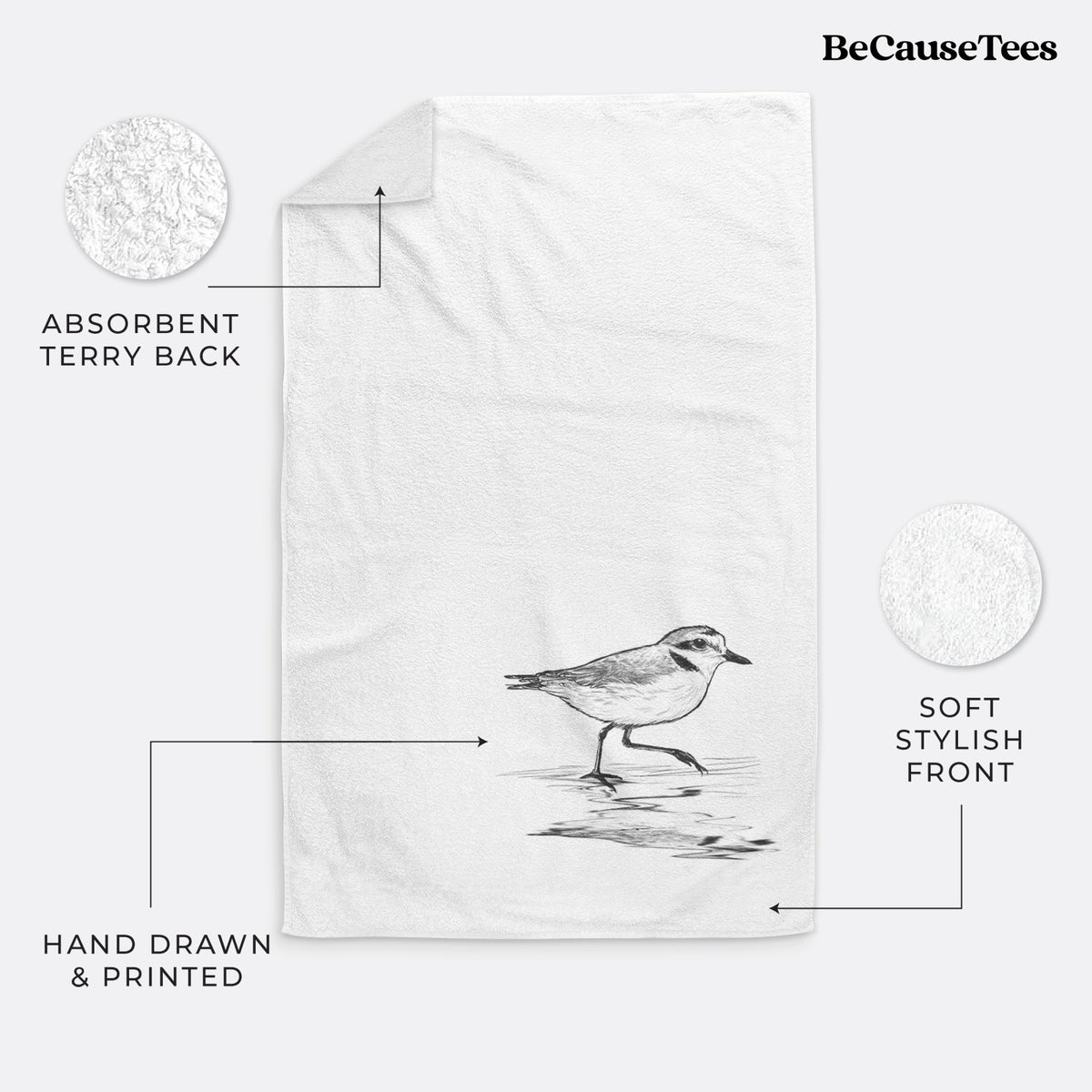 White hand towel printed with a black ink sketch of a snowy plover running along the wet shoreline.