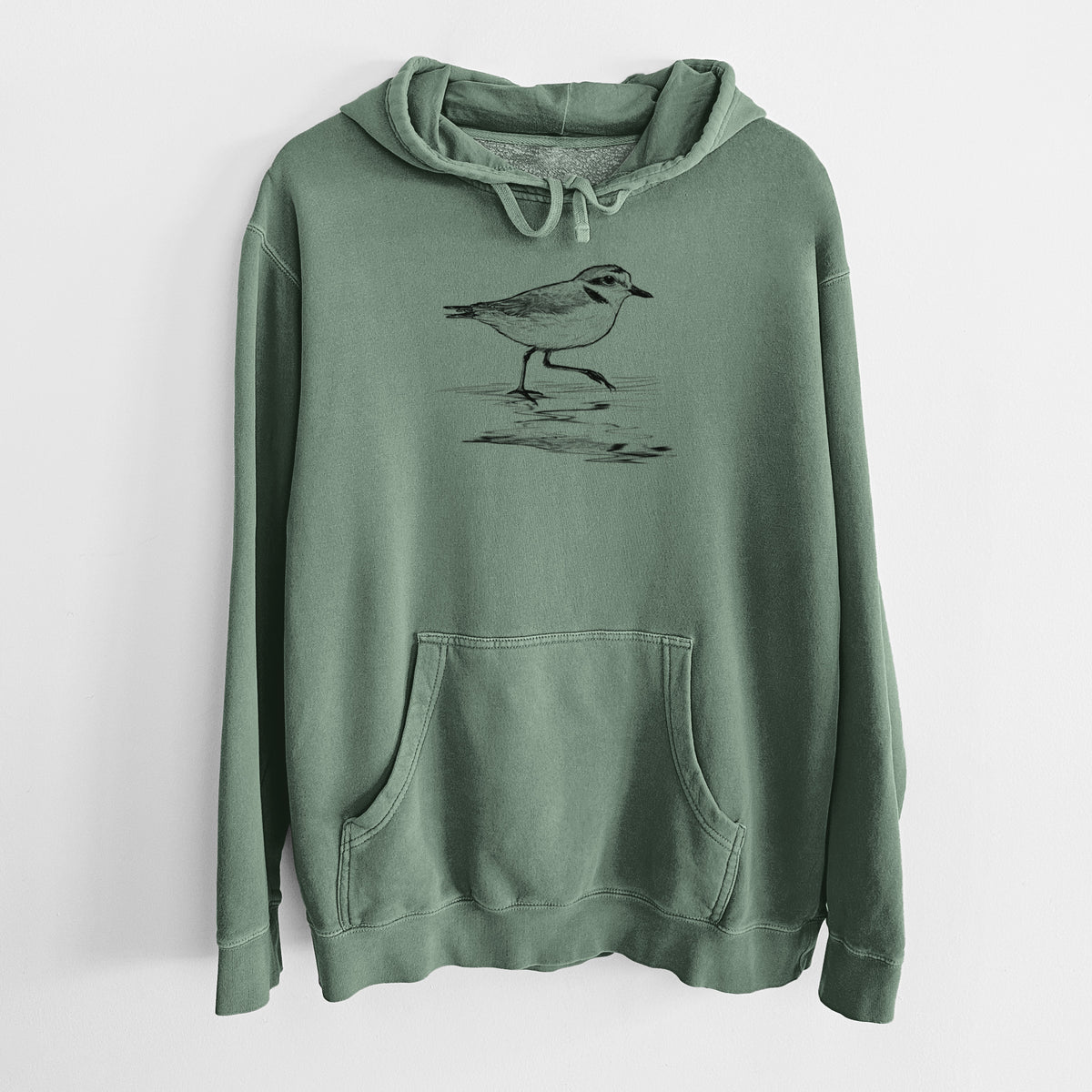 Alpine green pigment dyed hoodie laid flat, printed with a black ink sketch of a snowy plover running along the wet shoreline.