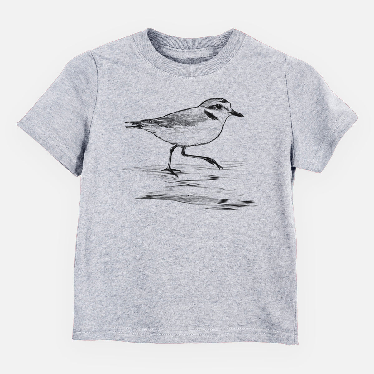 Heather grey toddler t-shirt laid flat, printed with a black ink sketch of a snowy plover running along the wet shoreline.
