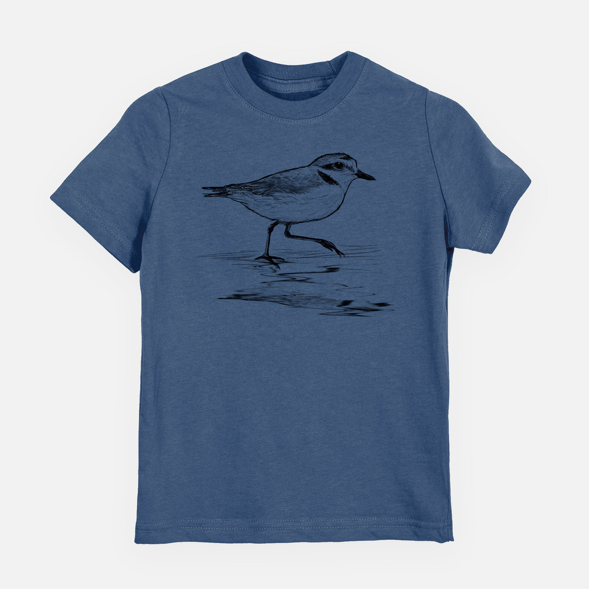 Indigo blue youth t-shirt laid flat, printed with a black ink sketch of a snowy plover running along the wet shoreline.