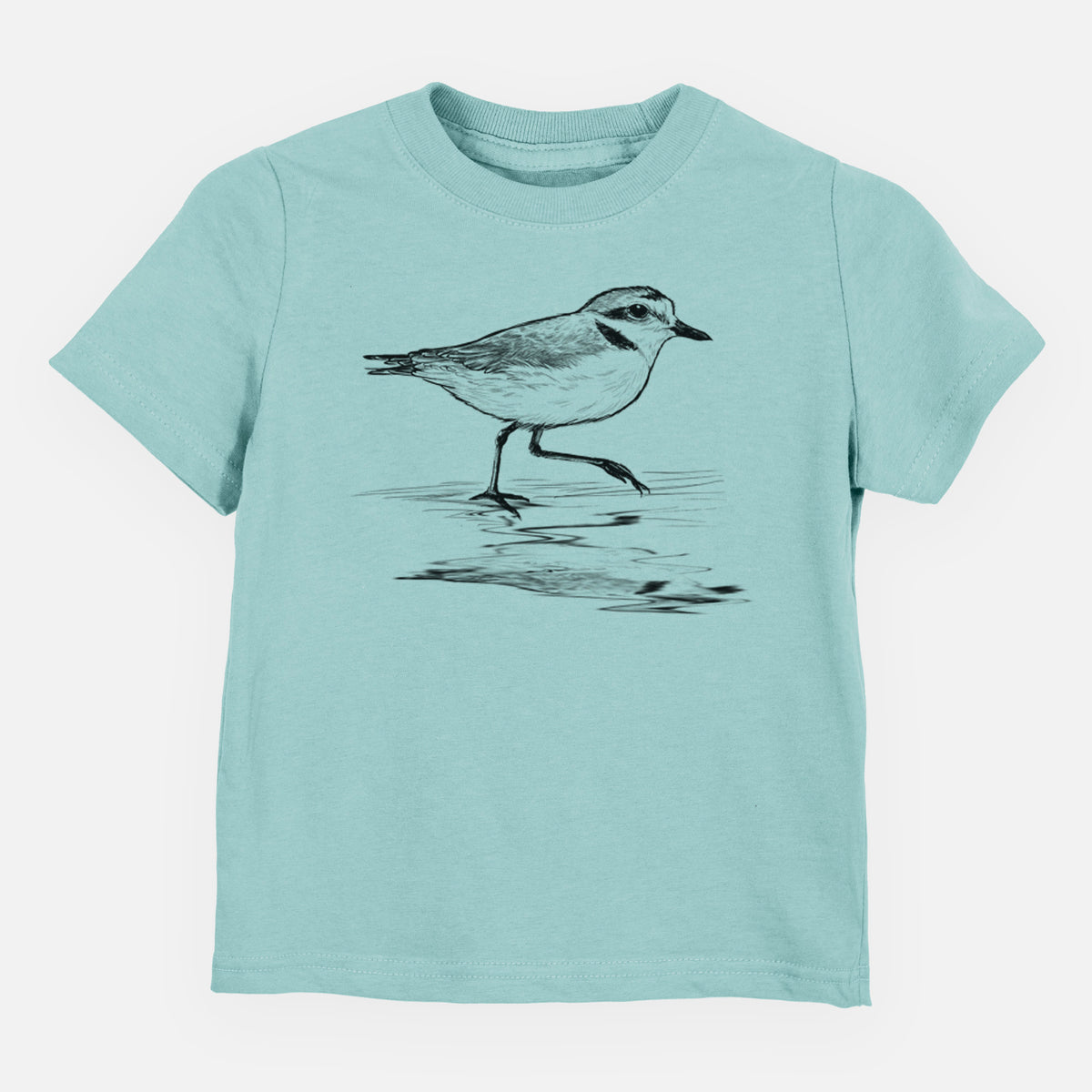 Saltwater toddler t-shirt laid flat, printed with a black ink sketch of a snowy plover running along the wet shoreline.