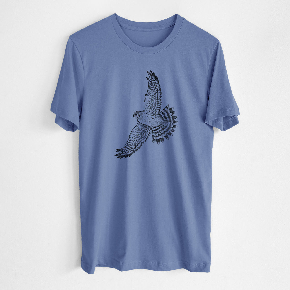 Blue bell lightweight cotton t-shirt laid flat, printed with a detailed black ink illustration of an American kestrel in flight with its wings raised.