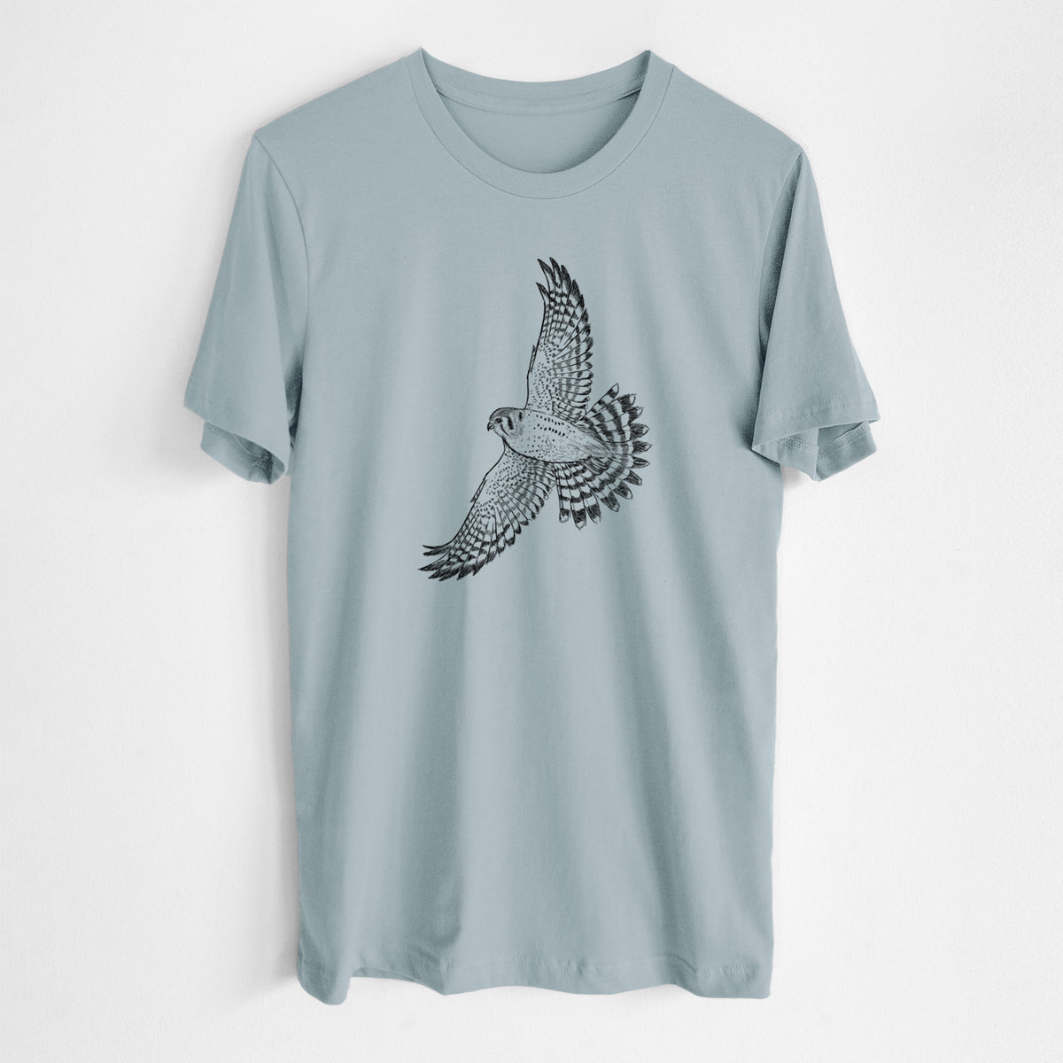 Vintage denim lightweight cotton t-shirt laid flat, printed with a detailed black ink illustration of an American kestrel in flight with its wings raised.