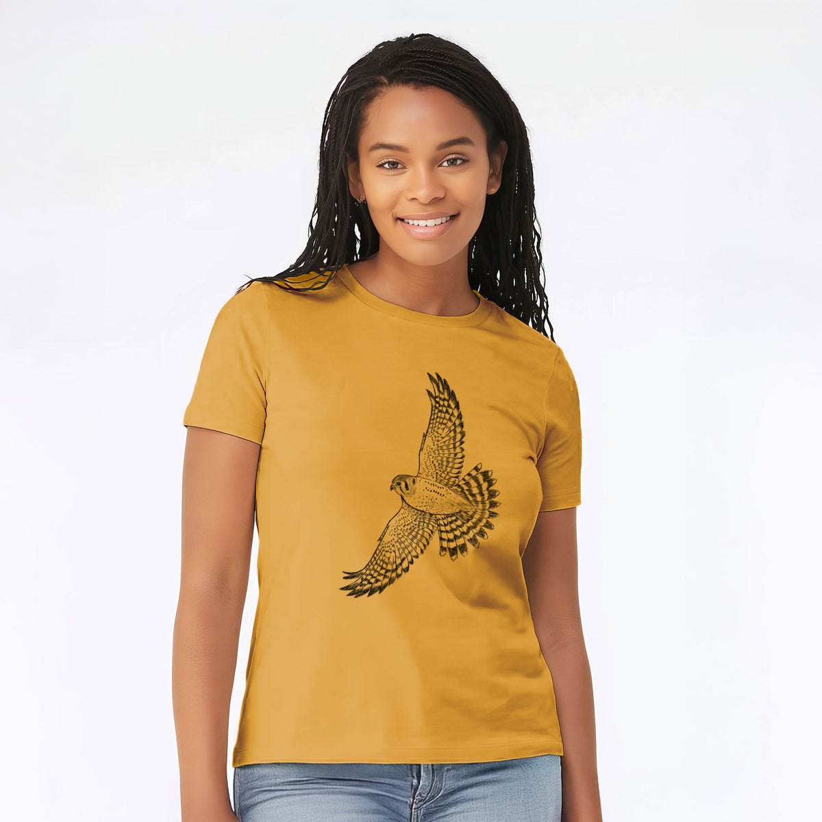 Woman wearing a mustard yellow women's relaxed fit cotton t-shirt printed with a detailed black ink illustration of an American kestrel in flight with its wings raised.