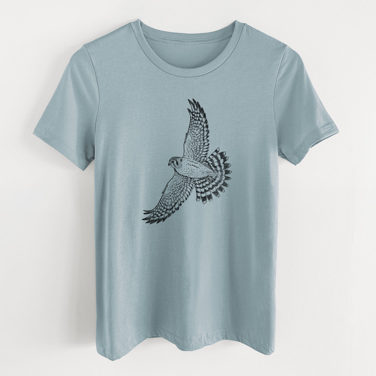 Vintage denim women's relaxed fit cotton t-shirt laid flat, printed with a detailed black ink illustration of an American kestrel in flight with its wings raised.