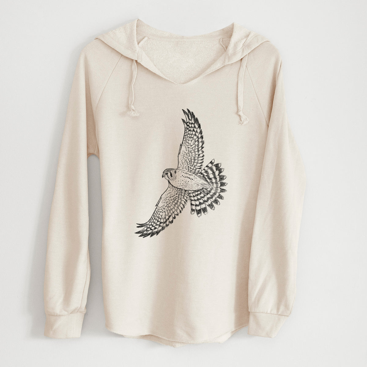 Bone cream women's Cali Wave hooded sweatshirt laid flat, printed with a detailed black ink illustration of an American kestrel in flight with its wings raised.