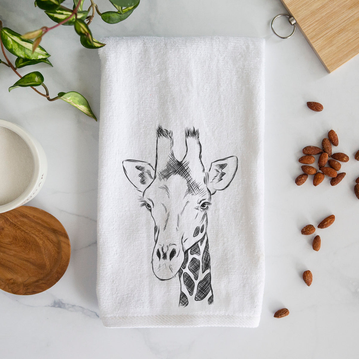 White hand towel printed with a black ink portrait of a southern giraffe's head and neck.