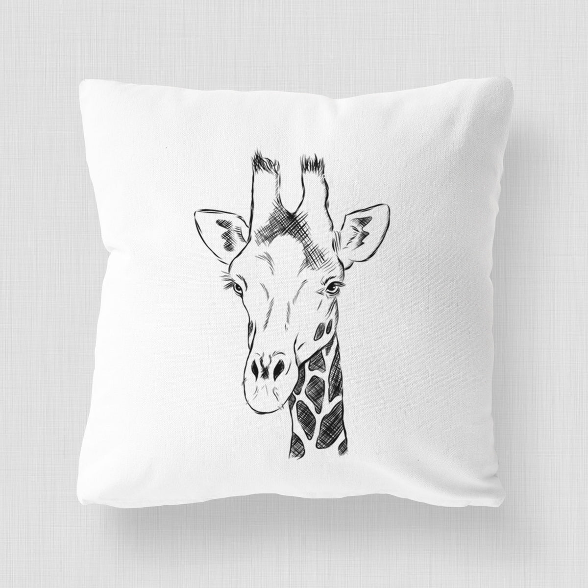 White pillow cover printed with a black ink portrait of a southern giraffe's head and neck.