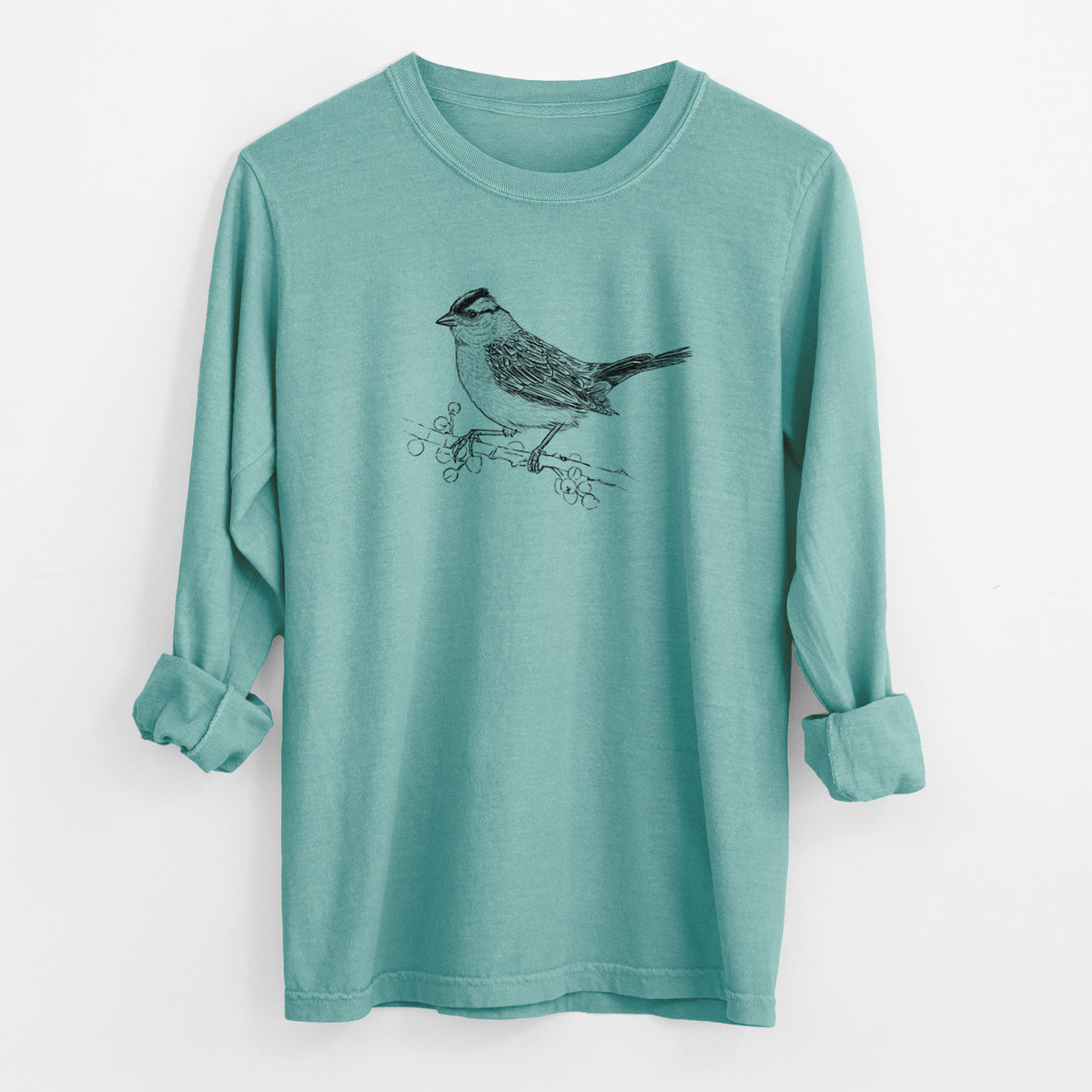 Reef green Comfort Colors long sleeve shirt laid flat with the cuffs rolled, printed with a detailed black ink sketch of a white-crowned sparrow perched on a branch.