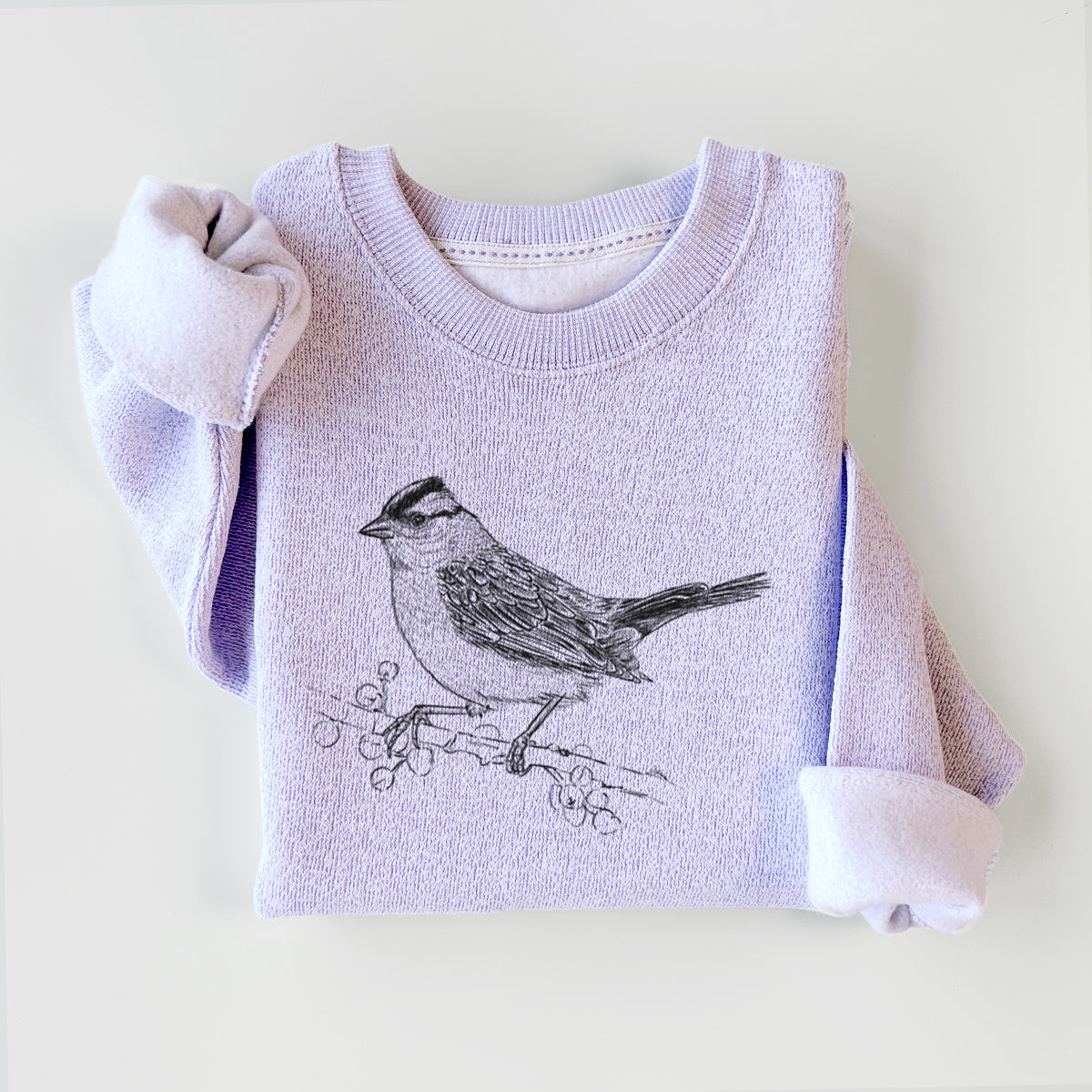Ice purple knit sweatshirt printed with a detailed black ink sketch of a white-crowned sparrow perched on a branch, styled flat.
