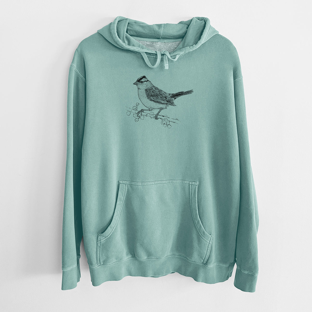 Mint green pigment dyed hoodie laid flat, printed with a detailed black ink sketch of a white-crowned sparrow perched on a branch.