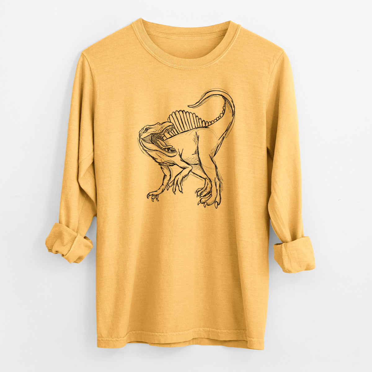 Golden wheat yellow Comfort Colors long sleeve shirt laid flat with the cuffs rolled, printed with a black ink illustration of a Spinosaurus with its tall sail-shaped back.