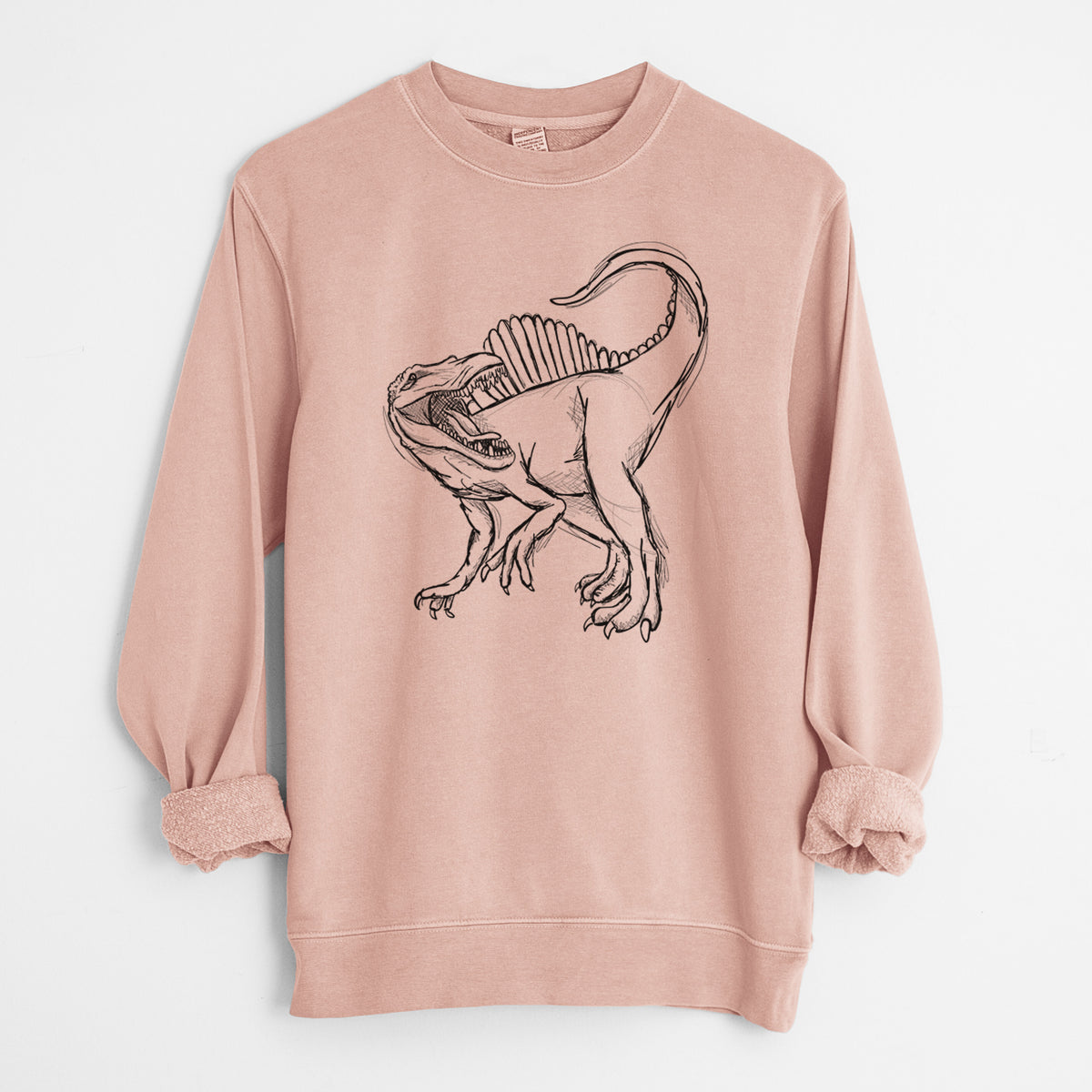 Dusty pink pigment dyed crewneck sweatshirt laid flat with the sleeves rolled, printed with a black ink illustration of a Spinosaurus with its tall sail-shaped back.