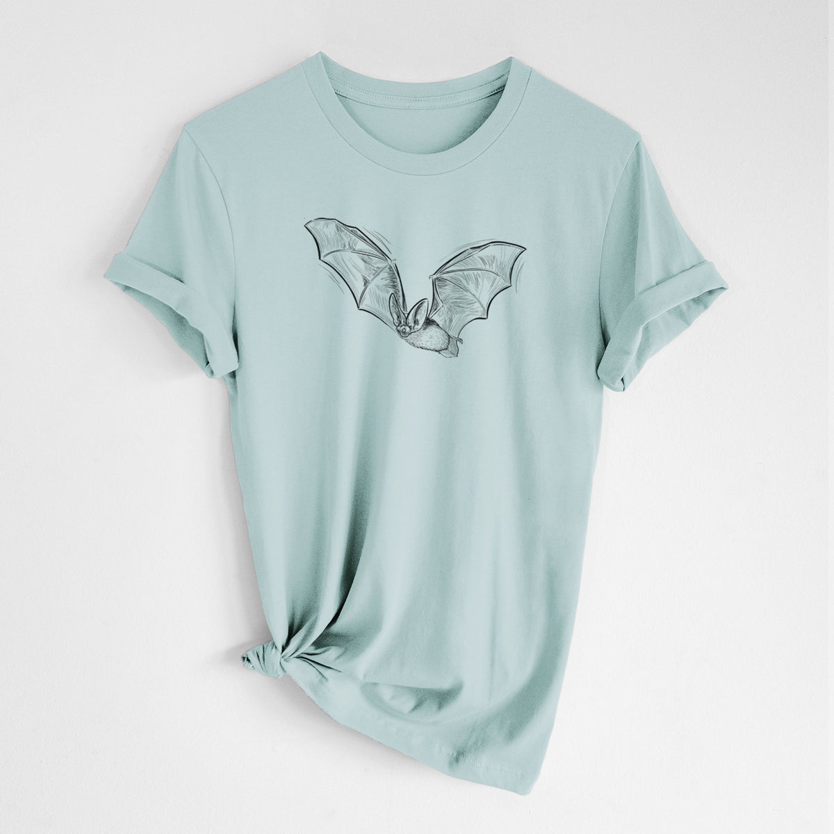 Dusty blue lightweight cotton t-shirt laid flat with the sleeves rolled, printed with a black ink illustration of a spotted bat in flight with large ears.