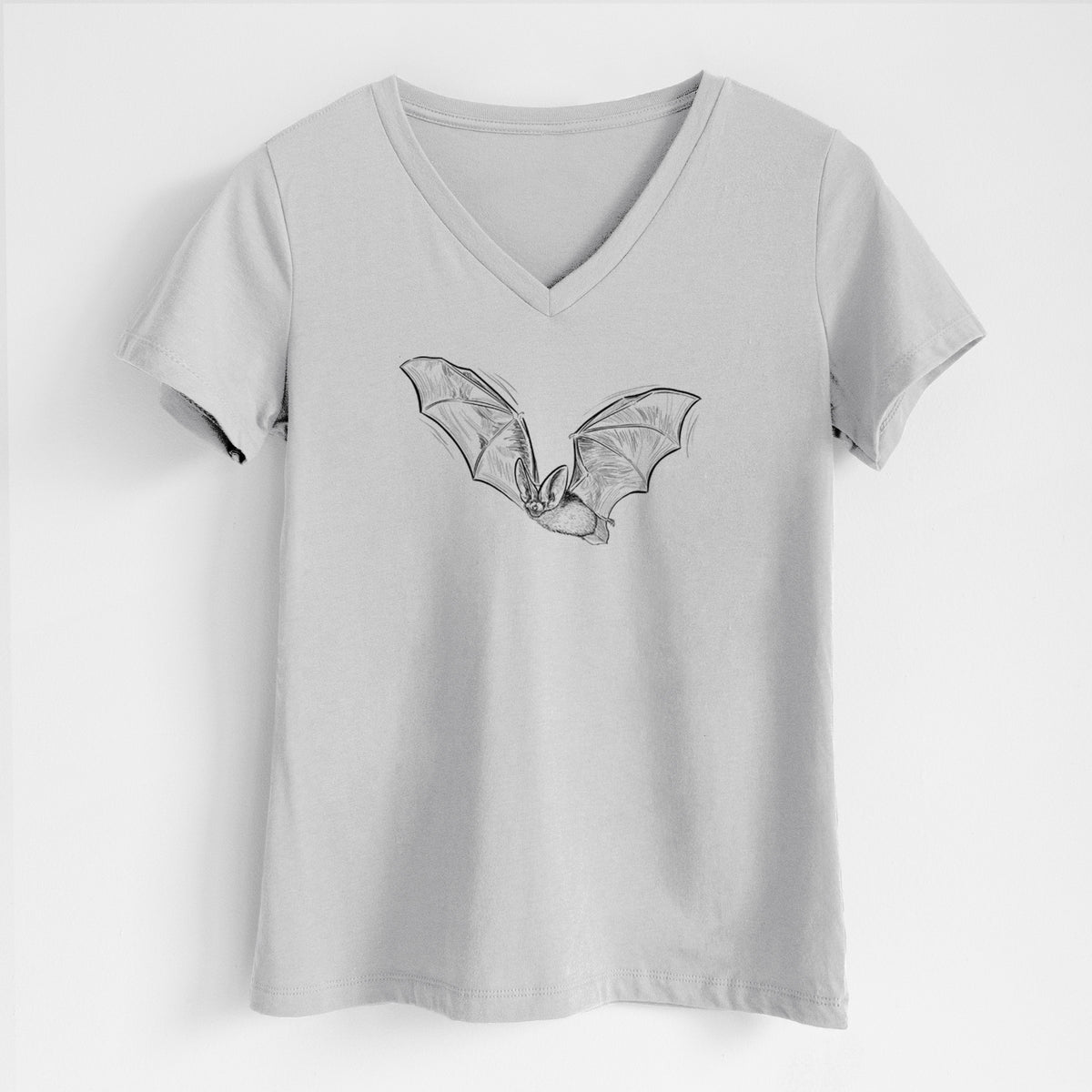 Lunar grey women's relaxed fit cotton V-neck t-shirt laid flat, printed with a black ink illustration of a spotted bat in flight with large ears.