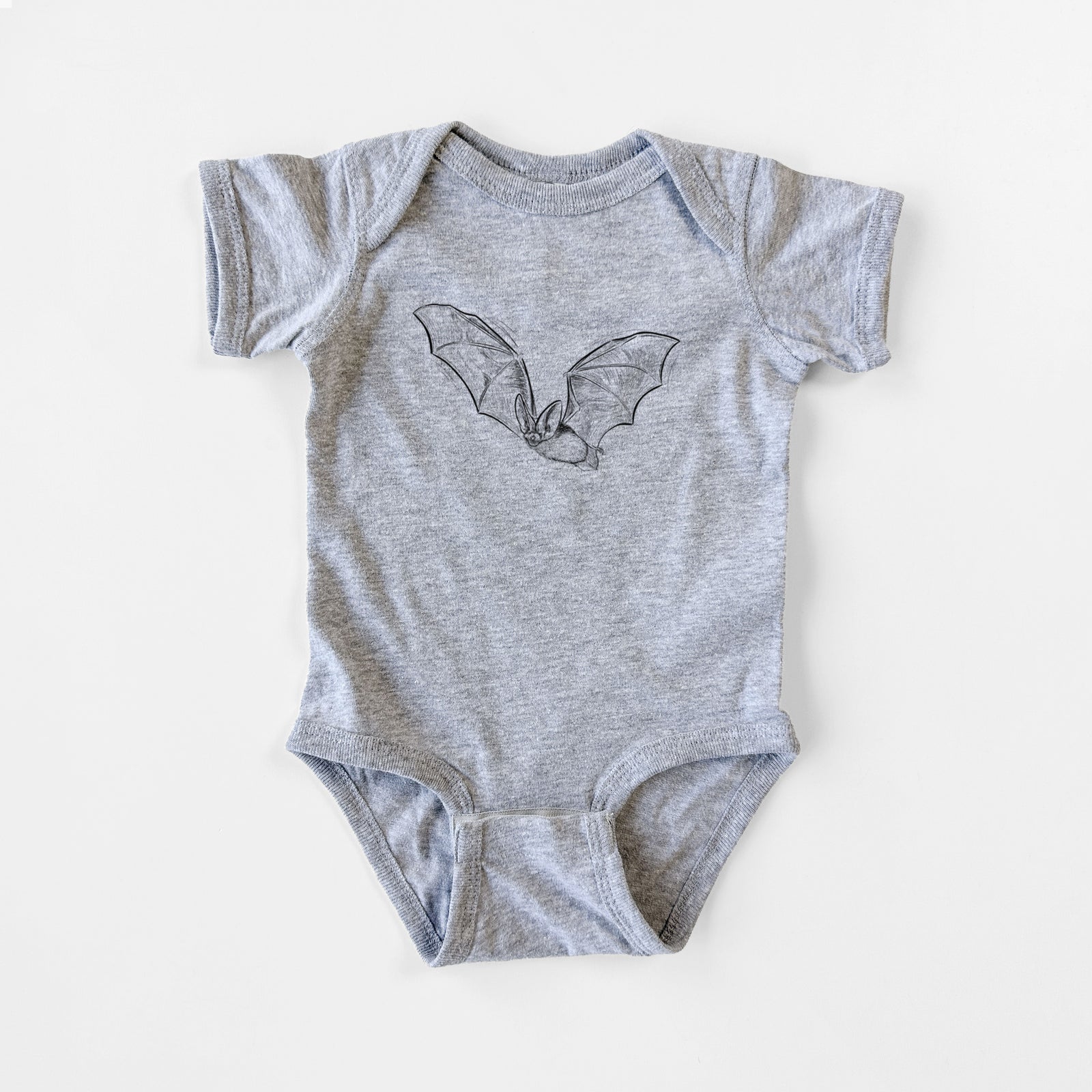 Grey baby bodysuit laid flat, printed with a black ink illustration of a spotted bat in flight with large ears.