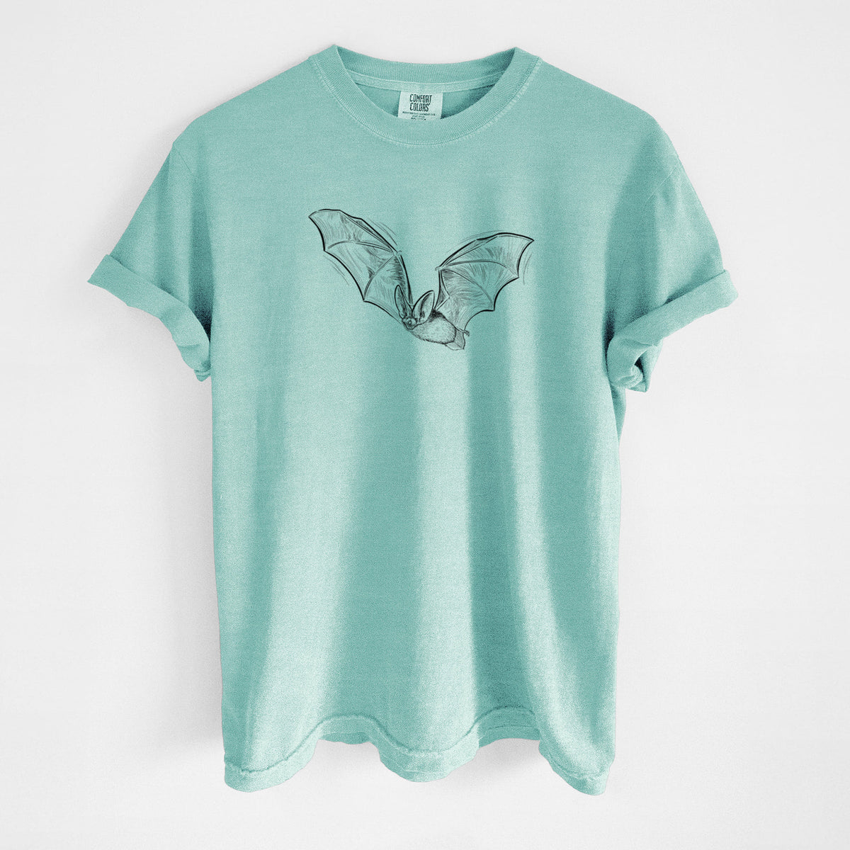 Chalky mint Comfort Colors t-shirt laid flat, printed with a black ink illustration of a spotted bat in flight with large ears.