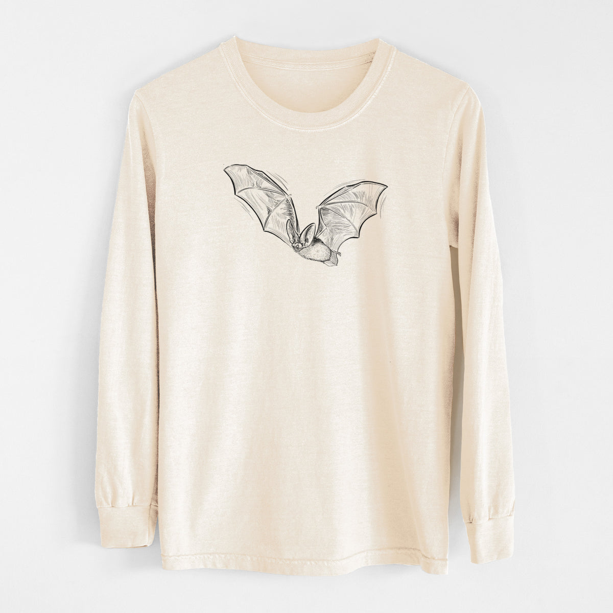 Ivory Comfort Colors long sleeve shirt laid flat, printed with a black ink illustration of a spotted bat in flight with large ears.
