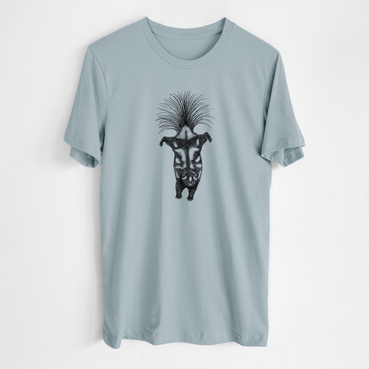 Vintage denim lightweight cotton t-shirt laid flat, printed with a black ink illustration of a spotted skunk doing a handstand with its tail fanned.