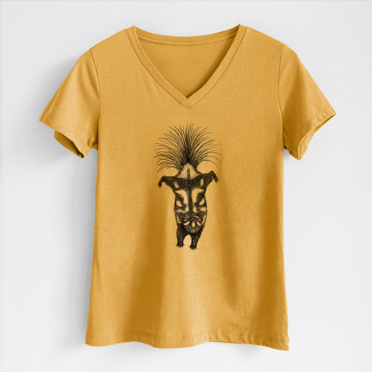 Honeycomb yellow women's relaxed fit cotton V-neck t-shirt laid flat, printed with a black ink illustration of a spotted skunk doing a handstand with its tail fanned.