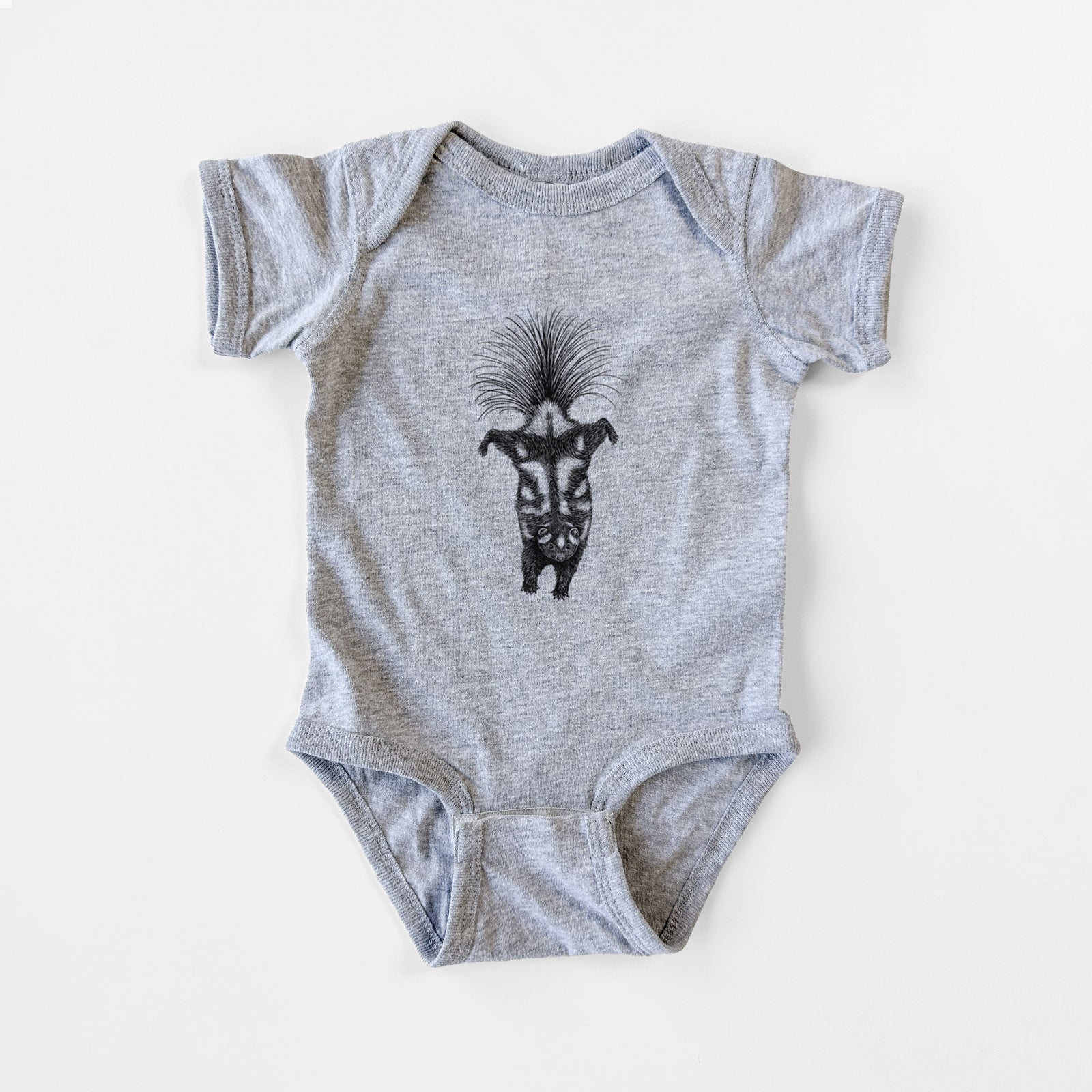 Grey baby bodysuit laid flat, printed with a black ink illustration of a spotted skunk doing a handstand with its tail fanned.