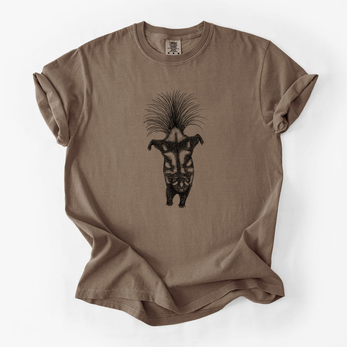 Espresso brown Comfort Colors t-shirt laid flat, printed with a black ink illustration of a spotted skunk doing a handstand with its tail fanned.