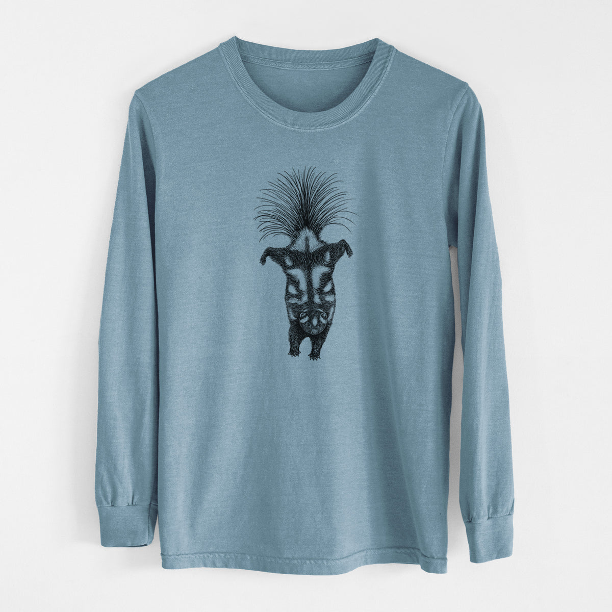 Steel blue Comfort Colors long sleeve shirt laid flat, printed with a black ink illustration of a spotted skunk doing a handstand with its tail fanned.
