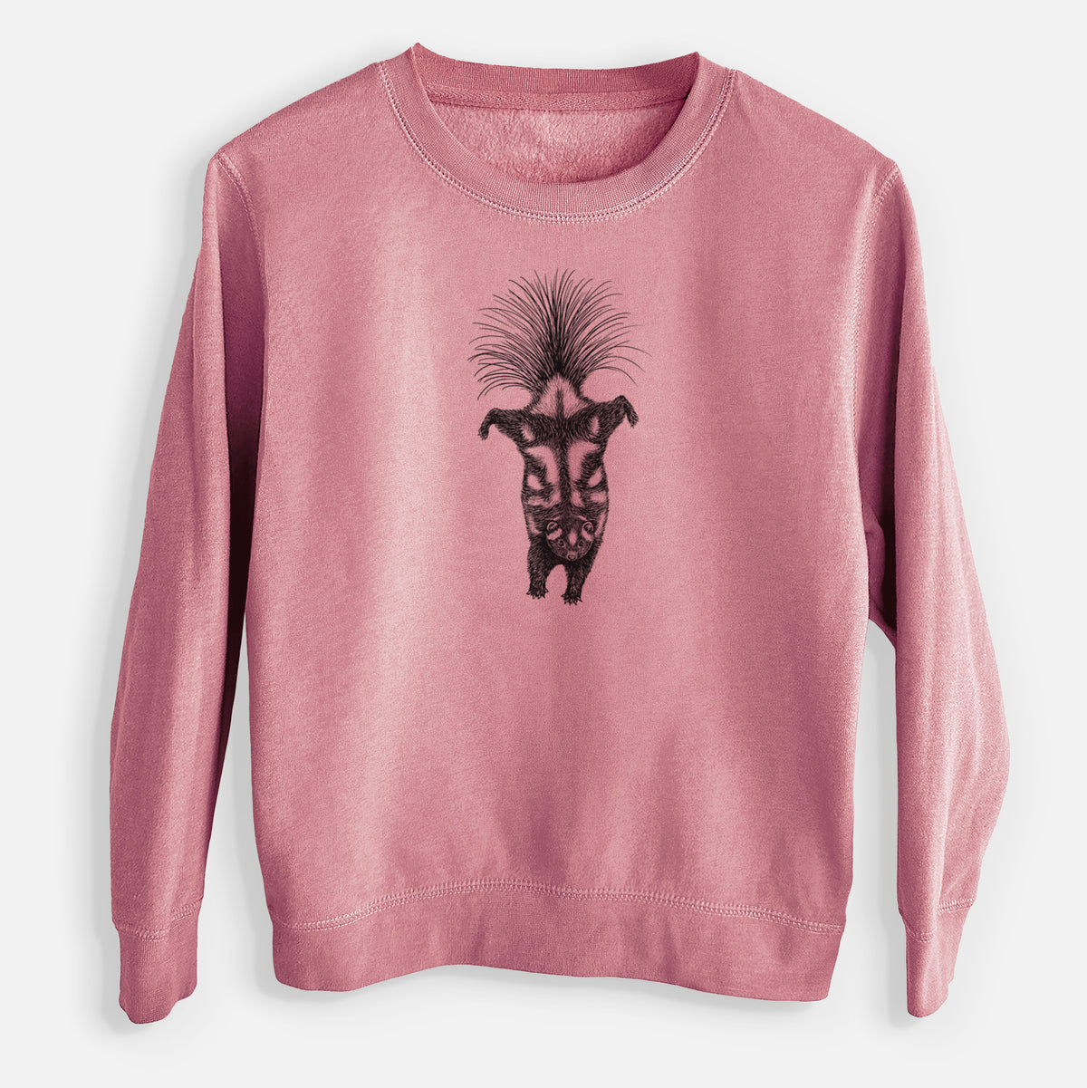 Mauve pink youth crewneck sweatshirt laid flat, printed with a black ink illustration of a spotted skunk doing a handstand with its tail fanned.