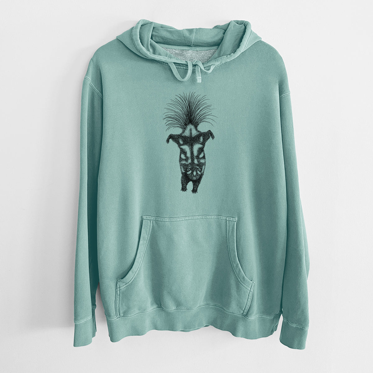 Mint green pigment dyed hoodie laid flat, printed with a black ink illustration of a spotted skunk doing a handstand with its tail fanned.