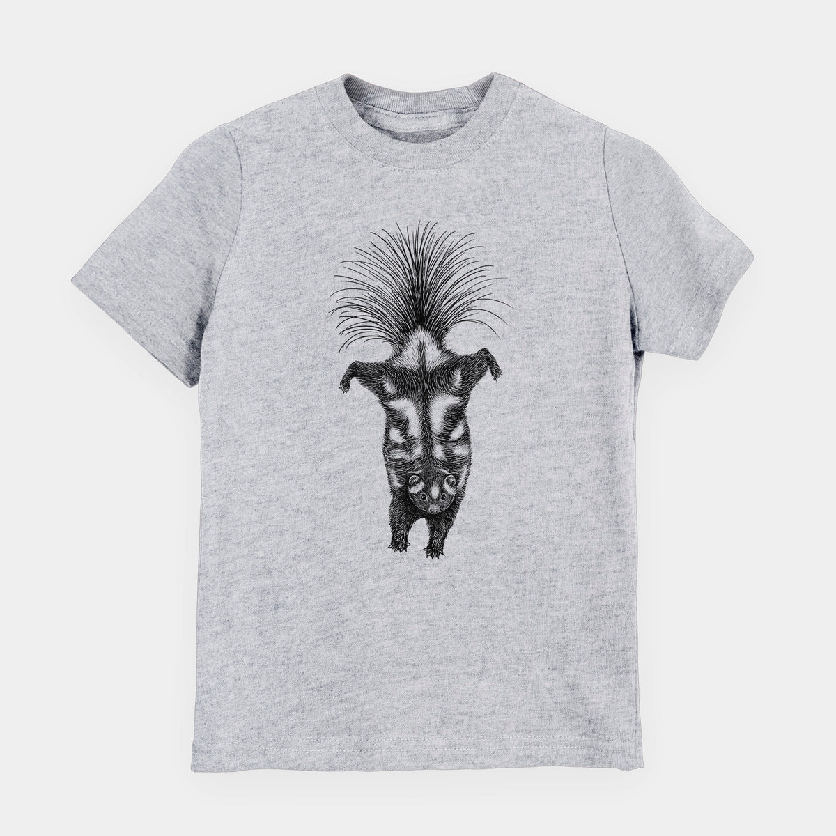 Heather grey youth t-shirt laid flat, printed with a black ink illustration of a spotted skunk doing a handstand with its tail fanned.