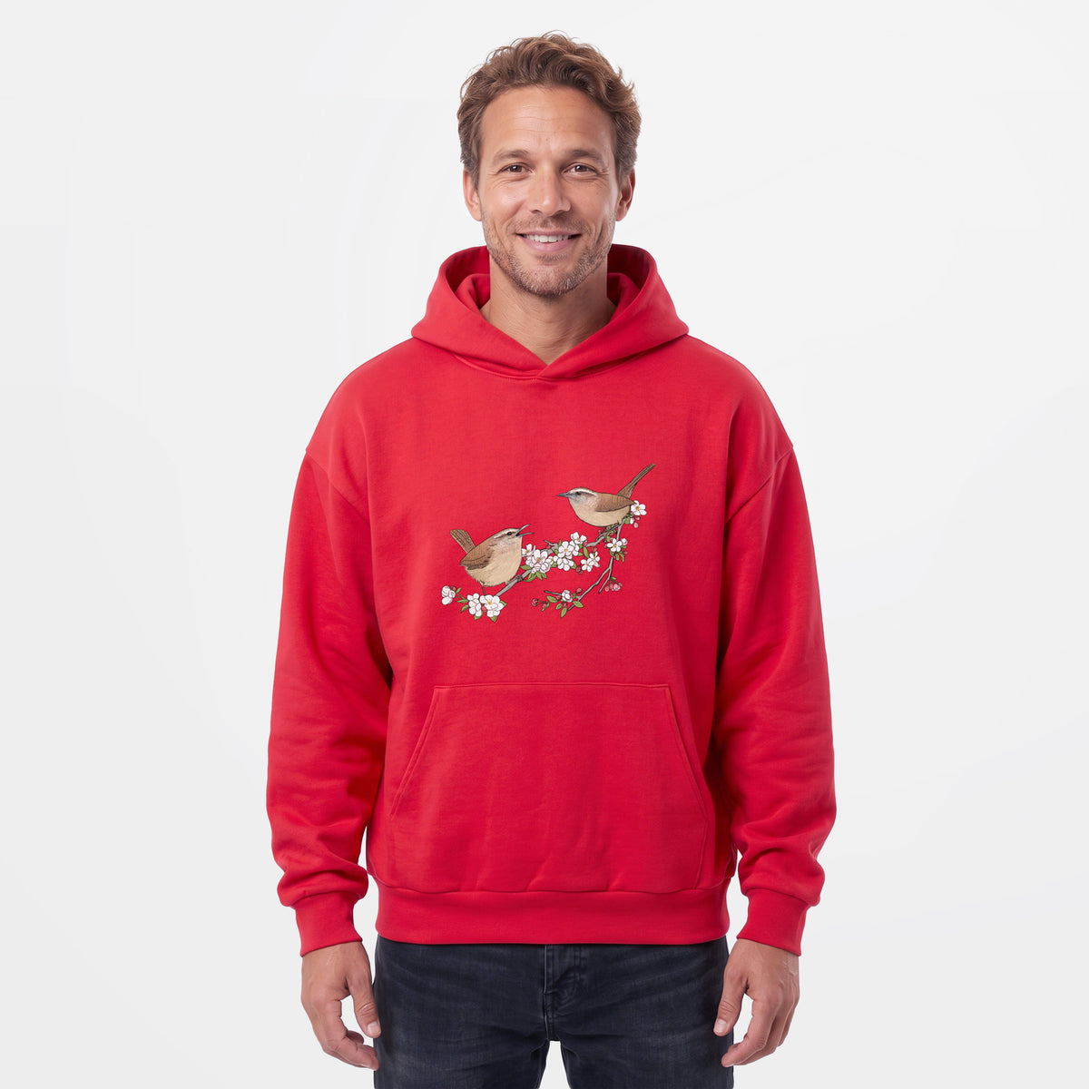 Male model wearing the Spring Carolina Wrens on a Blooming Crabtree Branch - Statement Midweight Hoodie.