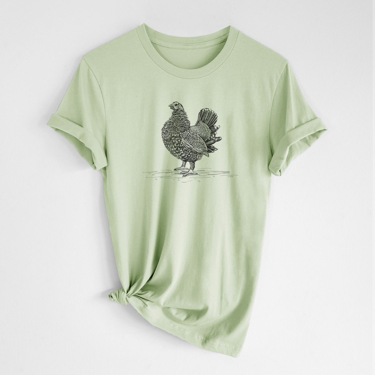 Spring green lightweight cotton t-shirt laid flat with the sleeves rolled, printed with a detailed black ink illustration of a spruce grouse standing with its tail fanned.