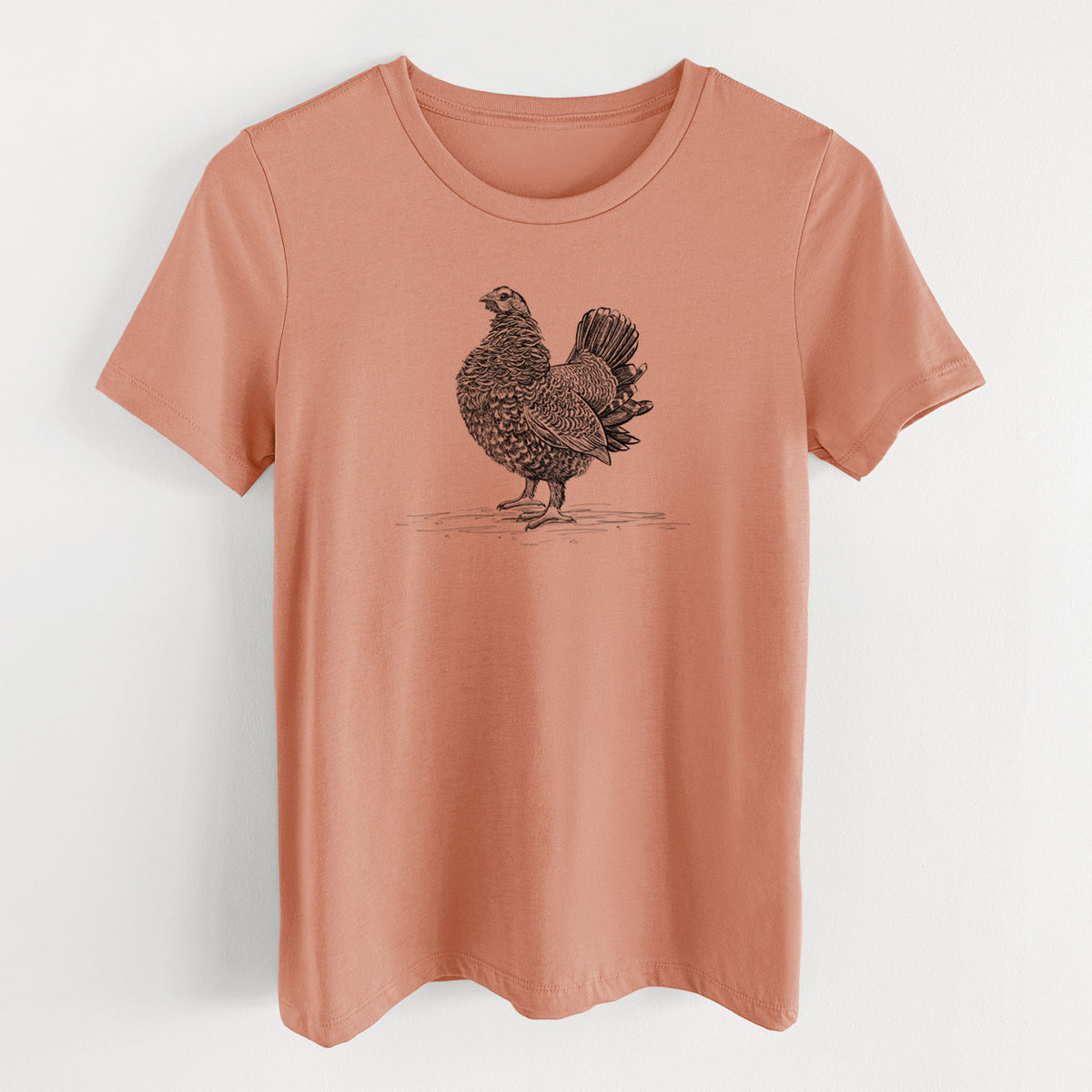 Terracotta orange women's relaxed fit cotton t-shirt laid flat, printed with a detailed black ink illustration of a spruce grouse standing with its tail fanned.