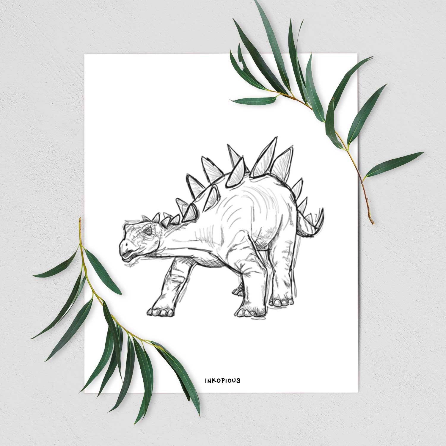 Art print of a black ink illustration of a Stegosaurus with plates along its back, shown with eucalyptus leaves.