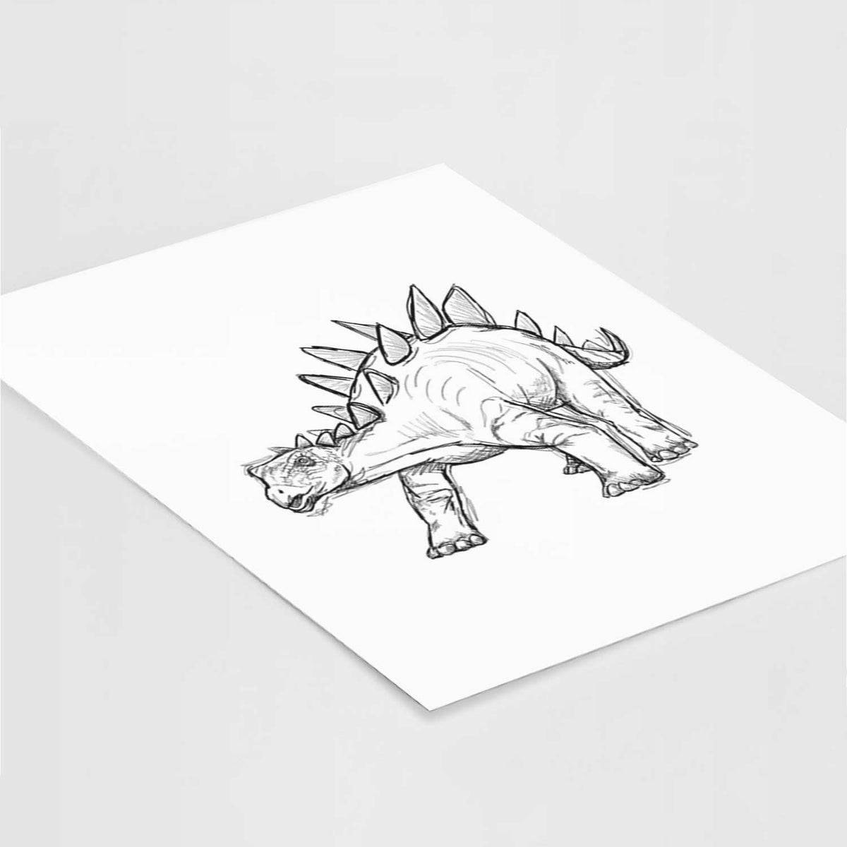 Art print of a black ink illustration of a Stegosaurus with plates along its back, lying at an angle on a white surface.