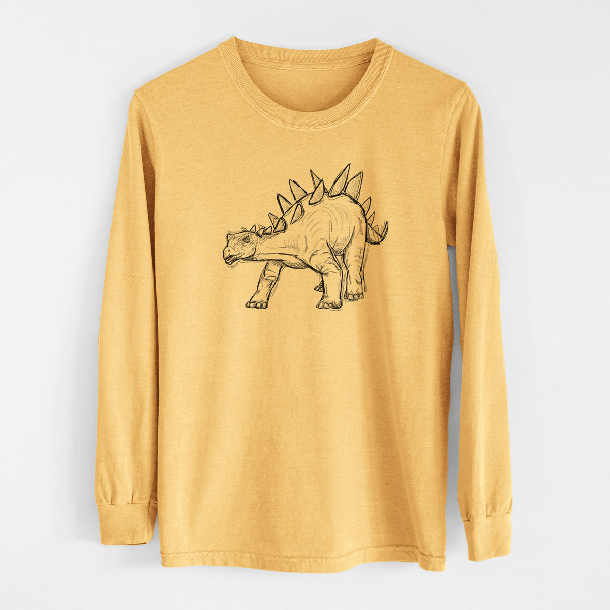 Golden wheat yellow Comfort Colors long sleeve shirt laid flat, printed with a black ink illustration of a Stegosaurus with plates along its back.