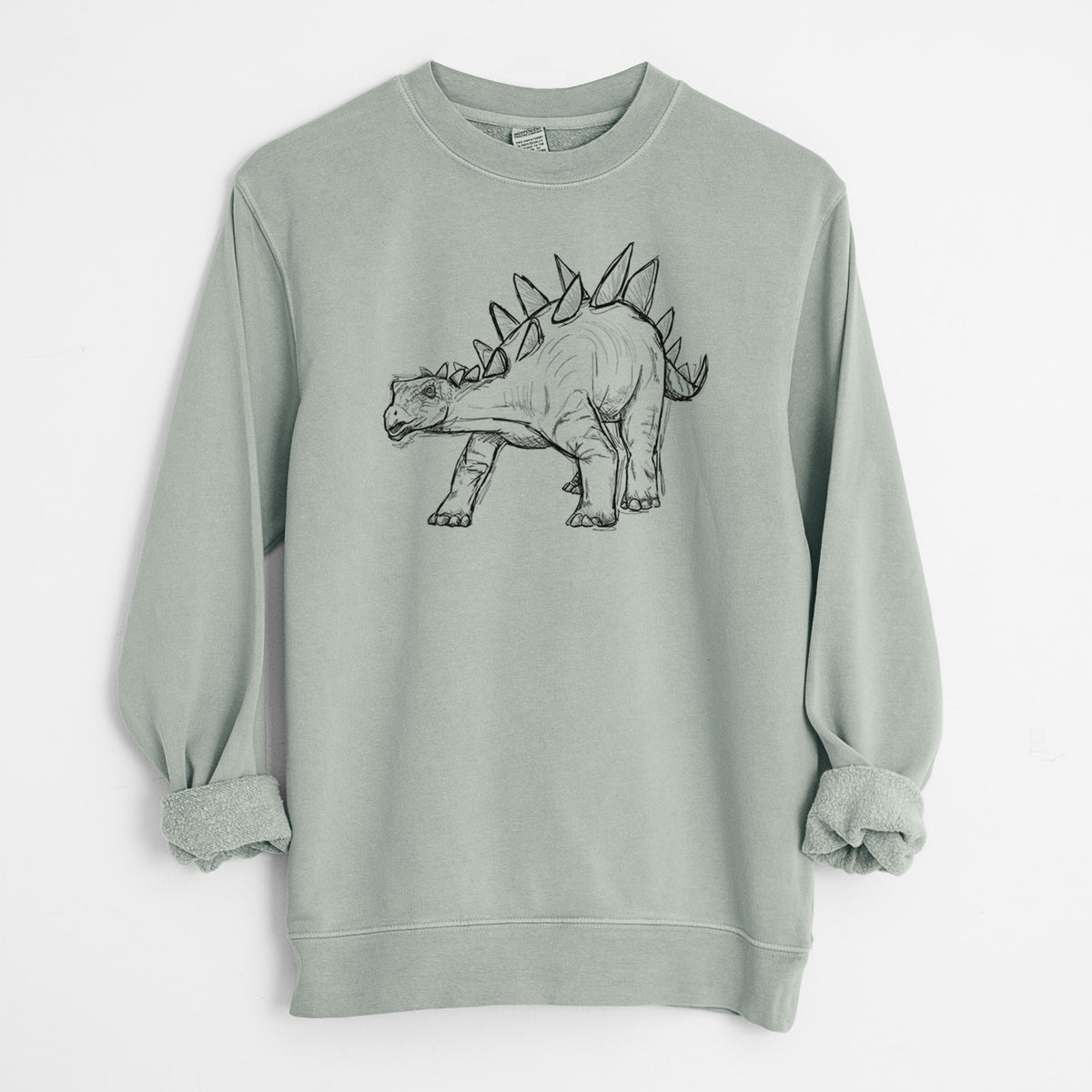 Sage green pigment dyed crewneck sweatshirt laid flat with the sleeves rolled, printed with a black ink illustration of a Stegosaurus with plates along its back.