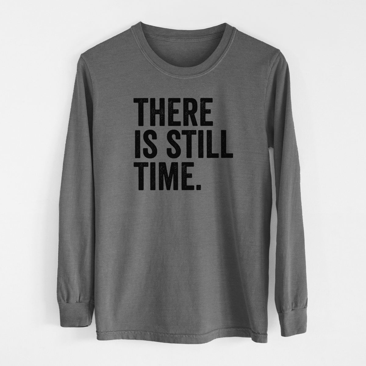 Pepper Comfort Colors long sleeve shirt laid flat, printed with bold black words reading There Is Still Time.