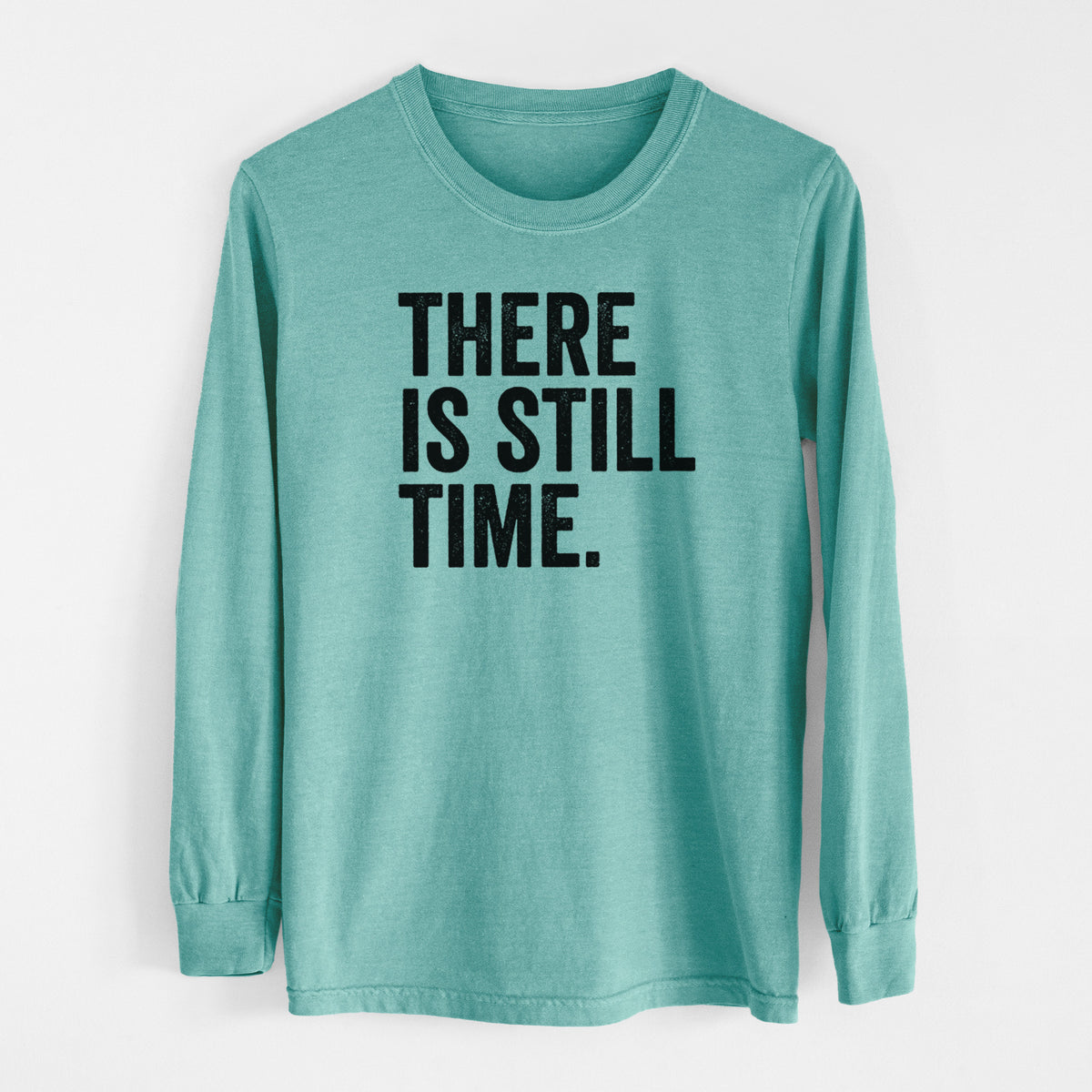 Reef green Comfort Colors long sleeve shirt laid flat, printed with bold black words reading There Is Still Time.