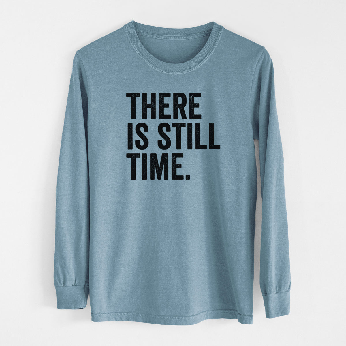 Steel blue Comfort Colors long sleeve shirt laid flat, printed with bold black words reading There Is Still Time.