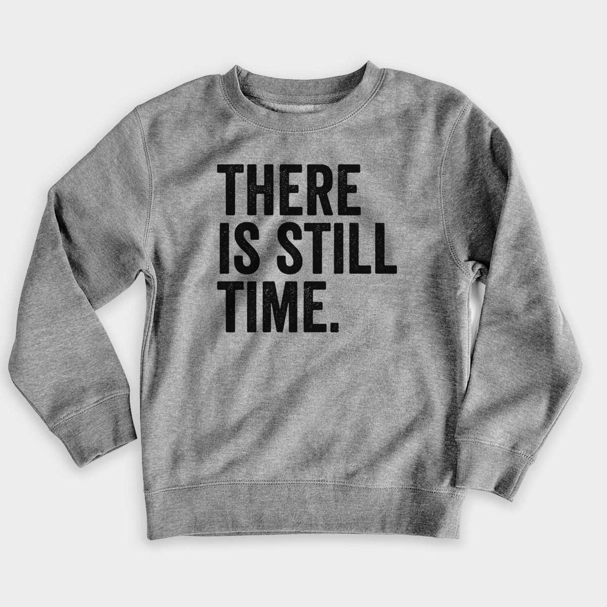 Nickel grey youth crewneck sweatshirt laid flat, printed with bold black words reading There Is Still Time.