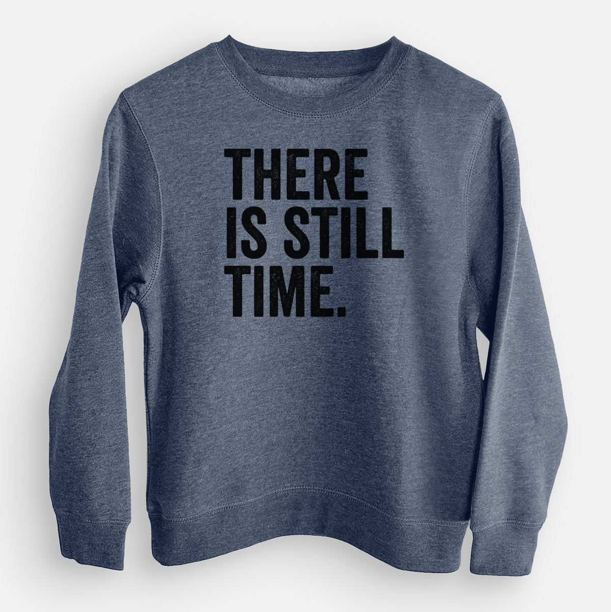 Storm blue youth crewneck sweatshirt laid flat, printed with bold black words reading There Is Still Time.