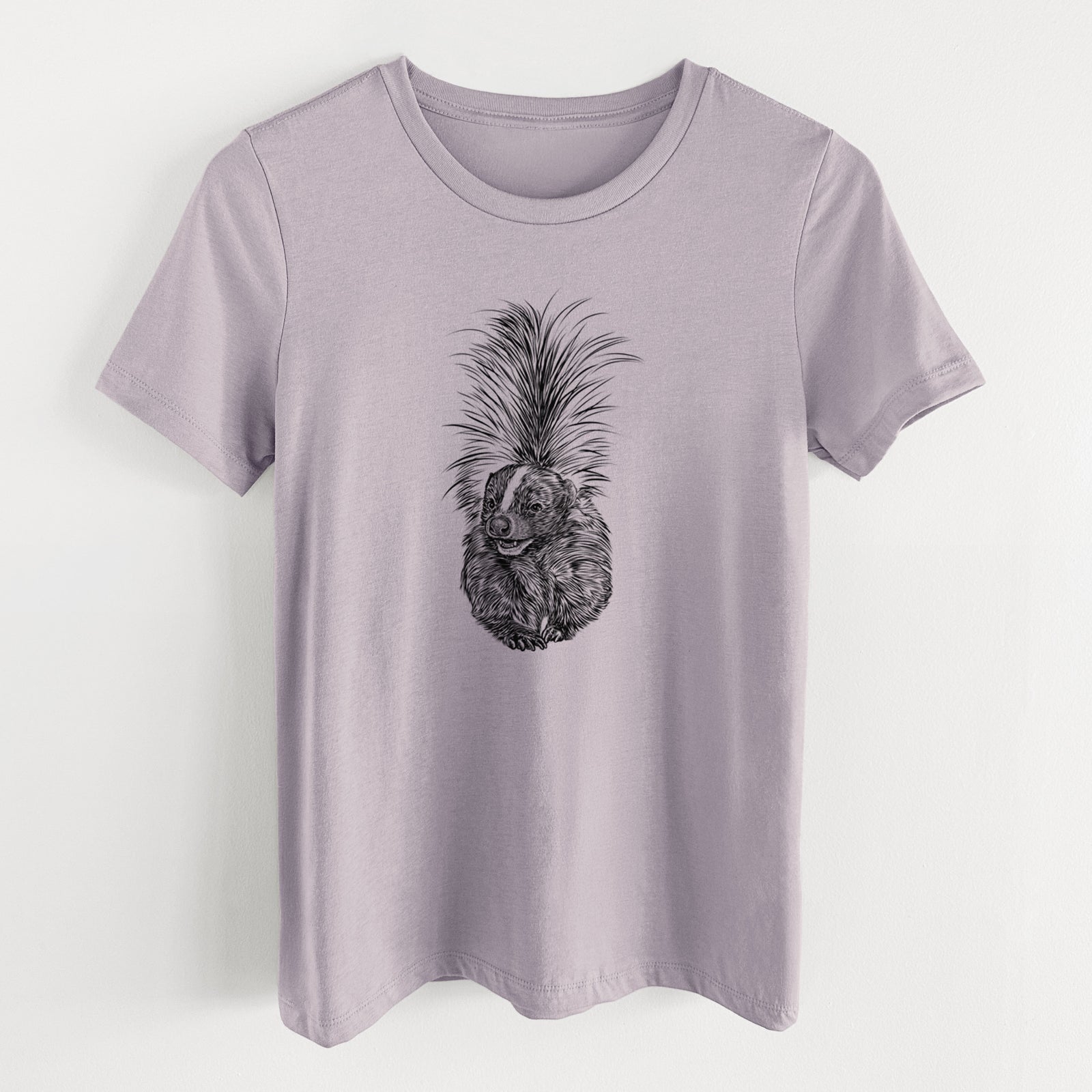 Light violet women's relaxed fit cotton t-shirt laid flat, printed with a detailed black ink illustration of a striped skunk with its tail raised.